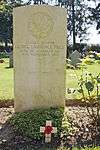 A headstone made of white Portland stone with the a maple leaf cap badge on top and George Lawrence Price, age and date of death below