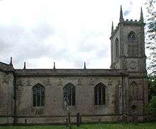 A stone church with a square tower