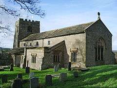 A plain stone church with a clerestory and a west tower.