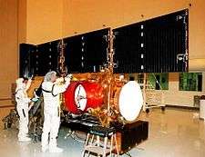 The solar arrays being checked in the Payload Hazardous Servicing Facility