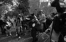 A pantomime horse is surrounded by media and police. Chaser member Chris Taylor on the obviously fake horse dressed like a police officer.