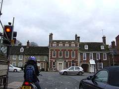 Traffic junction with Queen Anne redbrick house beyond