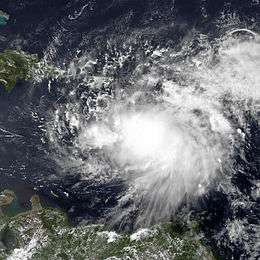 Satellite imagery of a disorganized tropical cyclone in the Caribbean Sea.