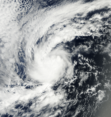 A visible satellite image depicting a small tropical storm well away from land on October 8.