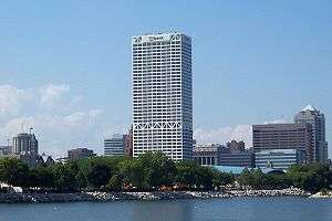 The U.S. Bank Center rises tall with several other buildings visible in the background from the lakefront.