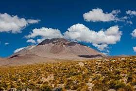 A flat mountain massif over a plain.