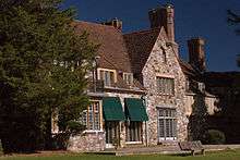 South-facing view of Hartford Hall, an English Tudor-style mansion.