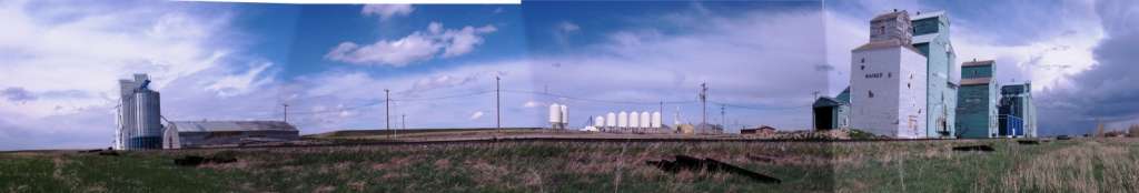 Elevator row against a partly-cloudy sky