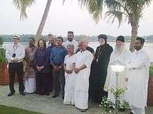 Group of people standing under palm trees