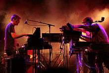 A photo showing Elektronische Staubband [Lionel Laquerriere (on the left), and Yann Tiersen and Thomas Poli (on the right)] live in concert at Lazzaretto of Ancona, Italy, on 21 July 2011.